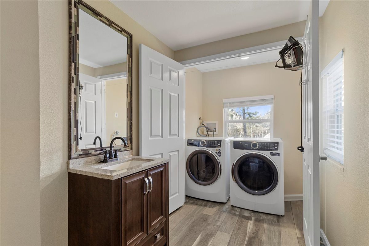 240 Riddle Road Cedar Creek, TX 78612 - Photo 21 of 31 a bathroom with a sink a mirror and washer