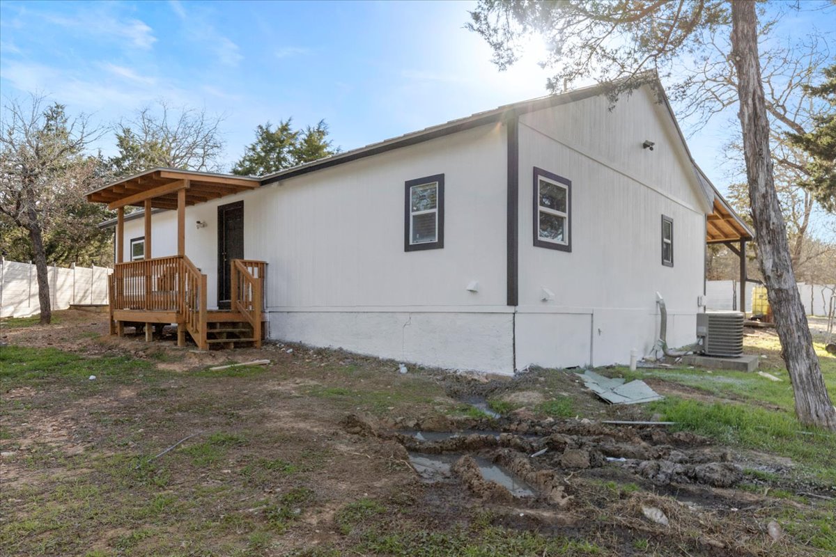 240 Riddle Road Cedar Creek, TX 78612 - Photo 22 of 31 a view of a house with backyard and a tree