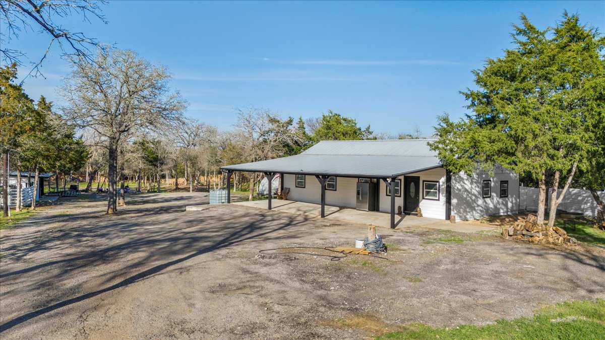 240 Riddle Road Cedar Creek, TX 78612 - Photo 23 of 31 a backyard of a house with table and chairs