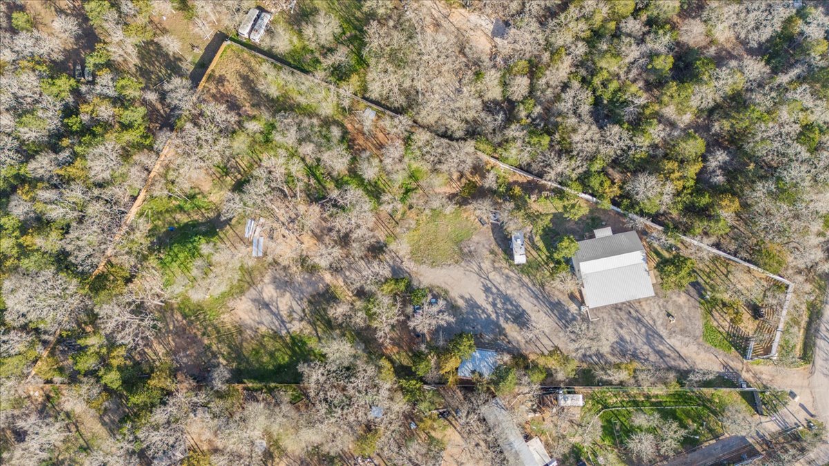 240 Riddle Road Cedar Creek, TX 78612 - Photo 30 of 31 a backyard of a house with a yard and garden