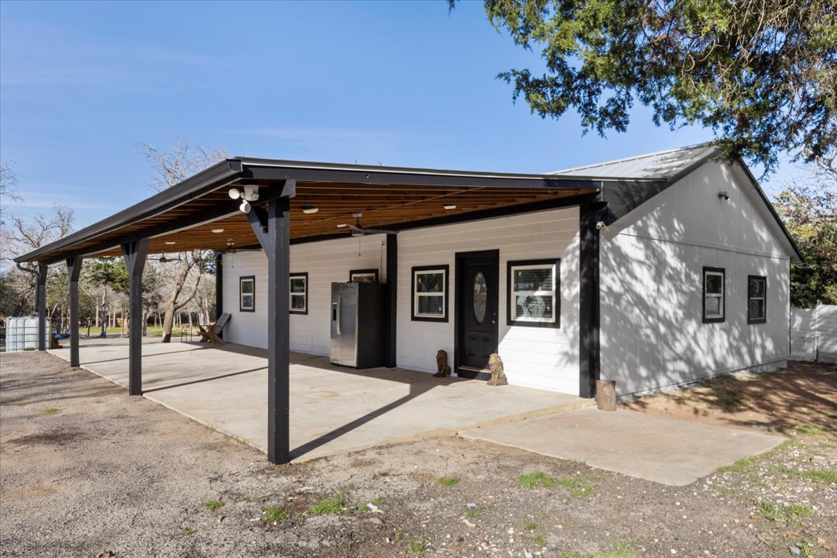 240 Riddle Road Cedar Creek, TX 78612 - Photo 4 of 31 a front view of a house with a garden
