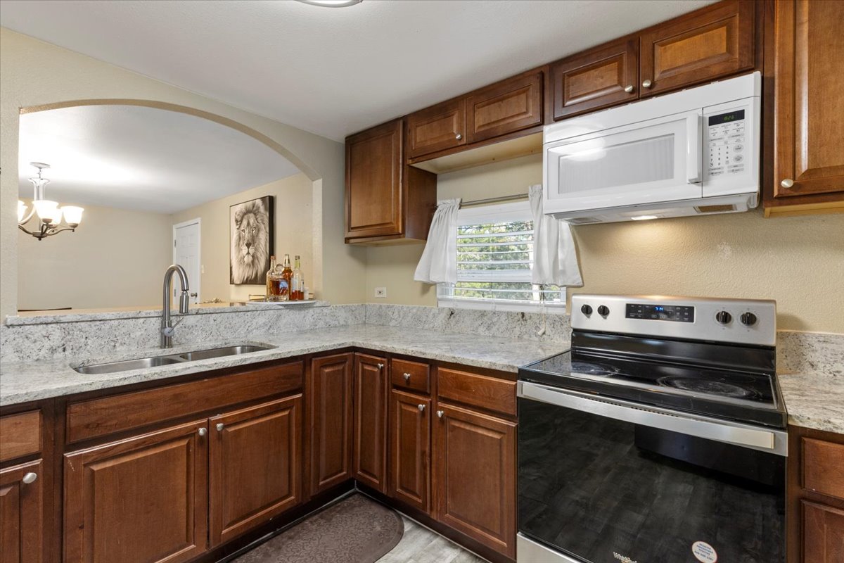 240 Riddle Road Cedar Creek, TX 78612 - Photo 9 of 31 a kitchen with stainless steel appliances granite countertop a sink stove and cabinets