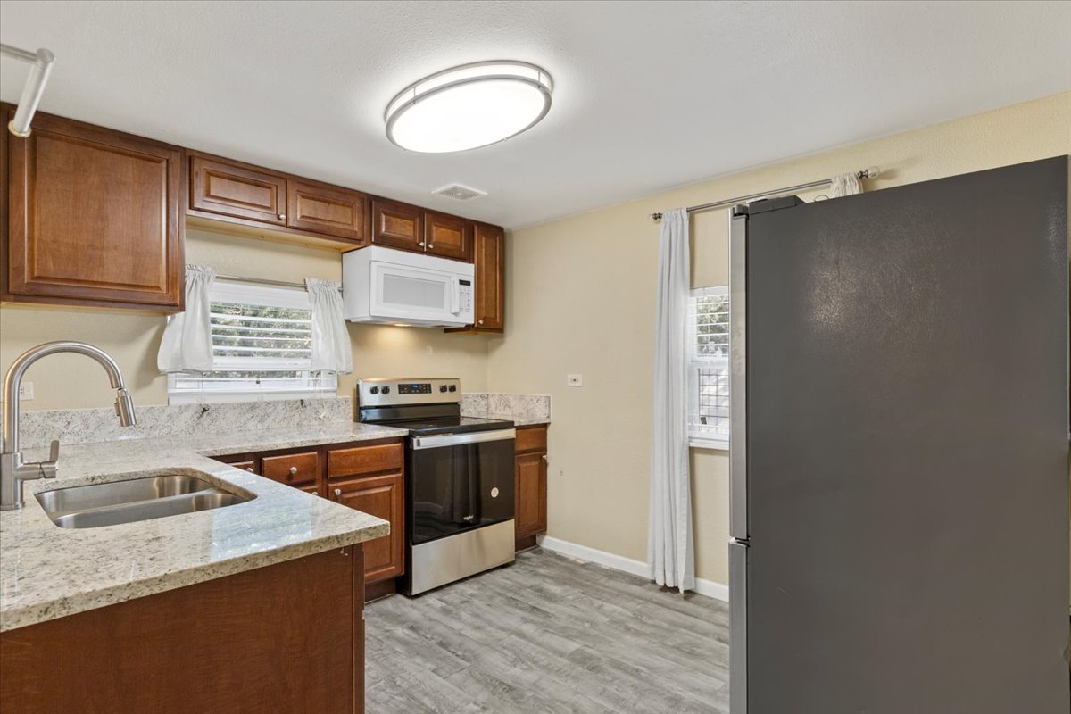 240 Riddle Road Cedar Creek, TX 78612 - Photo 10 of 31 a kitchen with stainless steel appliances granite countertop a sink stove and refrigerator