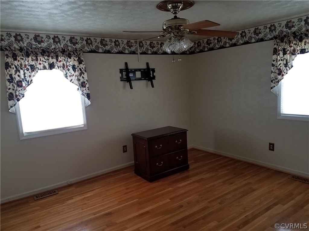 13104 South Chester Road Chester, VA 23831 - Photo 12 of 28 a room with a large mirror and a wooden floor