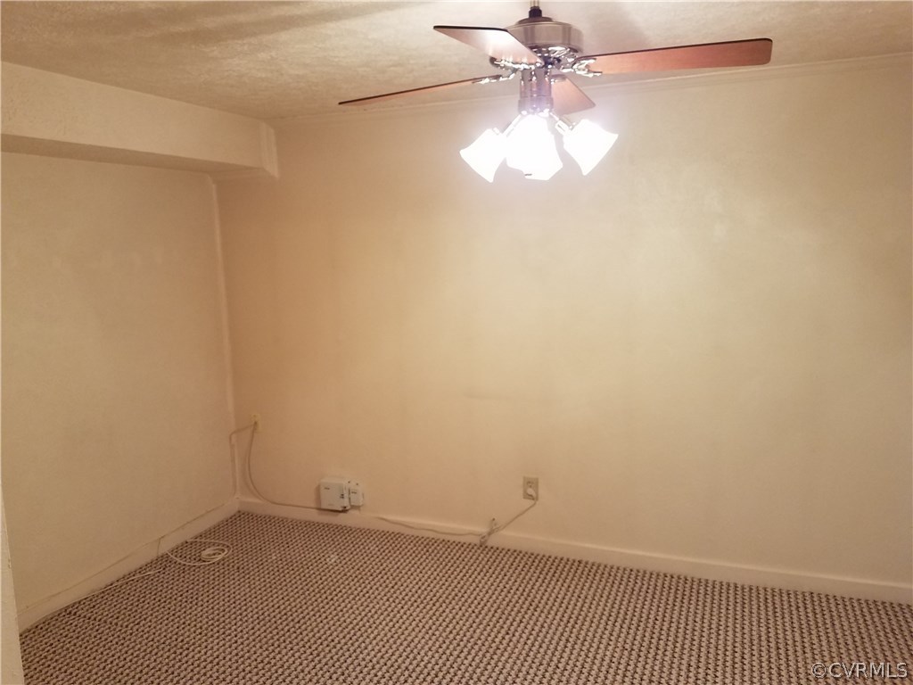 13104 South Chester Road Chester, VA 23831 - Photo 17 of 28 an empty room with a chandelier fan