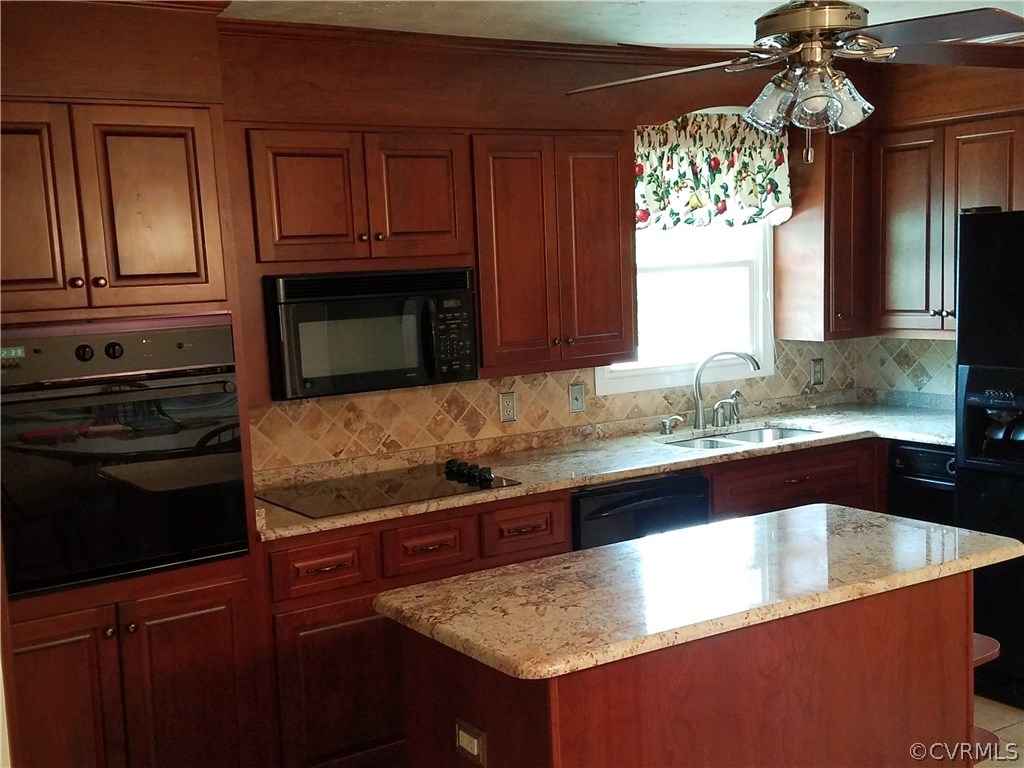 13104 South Chester Road Chester, VA 23831 - Photo 4 of 28 a kitchen with granite countertop a sink and a stove