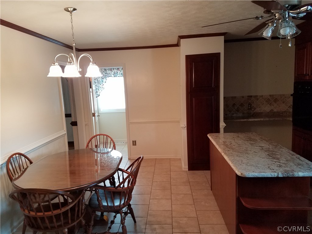 13104 South Chester Road Chester, VA 23831 - Photo 6 of 28 a dining room with a table and chairs