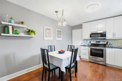 a dining room with furniture and wooden floor