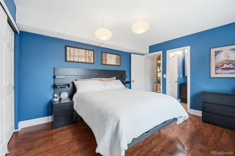 a bedroom with a bed and a night stand