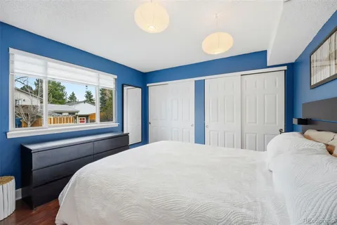 a bedroom with a large bed and a large window