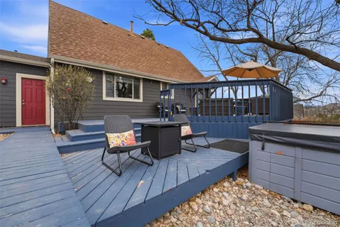 a roof deck with a table and chairs under an umbrella