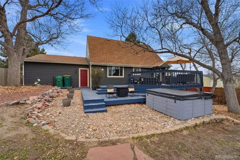 a view of a house with backyard and sitting area