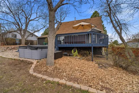a view of a house with a yard covered in snow