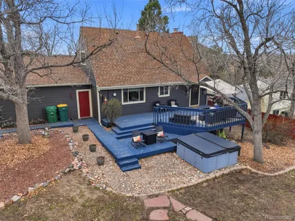 a front view of house with yard outdoor seating and covered with trees