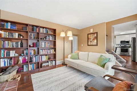a living room with furniture and a book shelf