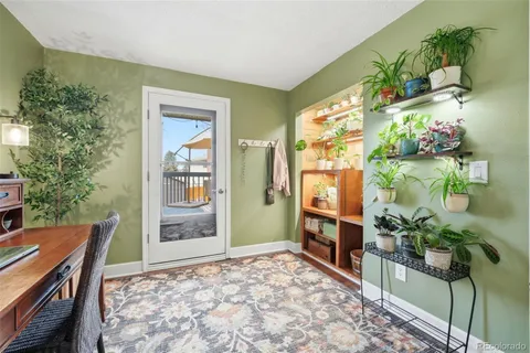 a room with painting on the table and a potted plant