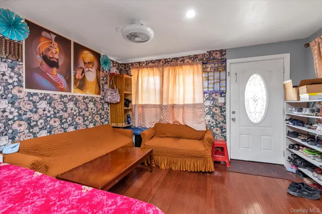 a bedroom with furniture and a large window