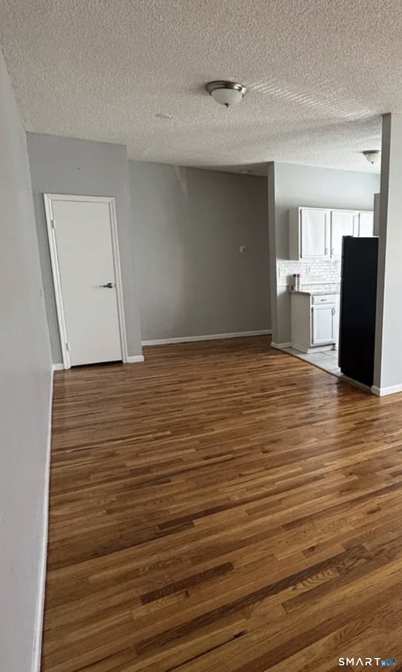 335 Wells Street, Unit 2 Bridgeport, CT 06606 - Photo 2 of 3 a view of empty room with wooden floor