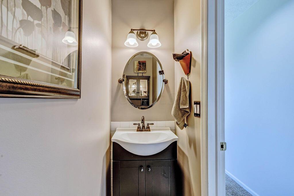 1300 Hubbard Road Galloway, OH 43119 - Photo 15 of 89 • Ceramic tile flooring • Tan painted walls • Ceiling exhaust • Wall cabinet remains • New enclosed vanity with single bowl sinktop ~ 2016 • Two-bulb wall light • New toilet ~ 2016