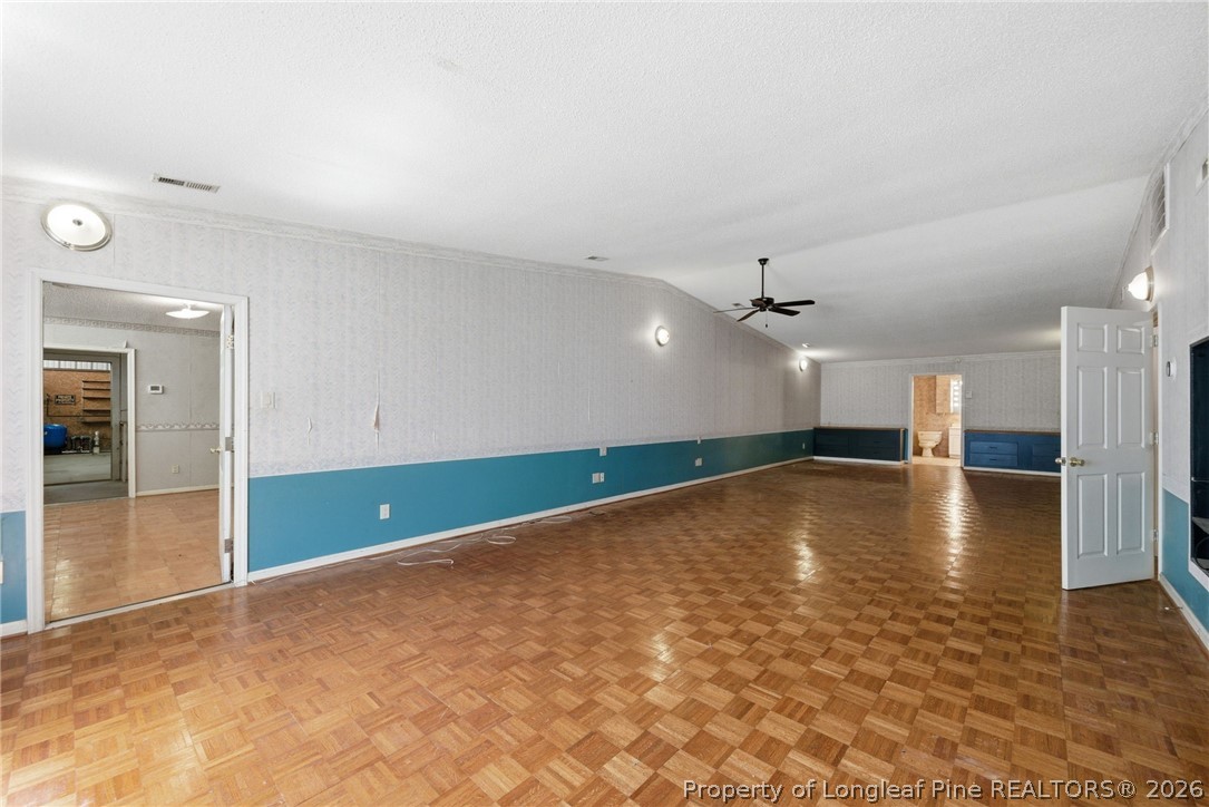 478 Rattlesnake Trail Aberdeen, NC 28315 - Photo 31 of 44 an empty room with wooden floor and ceiling fan