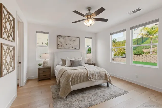 a bedroom with a large bed and a window