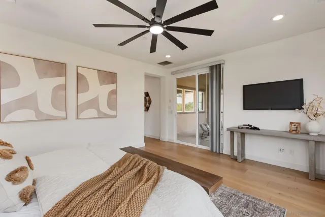 a bedroom with a bed and a flat screen tv