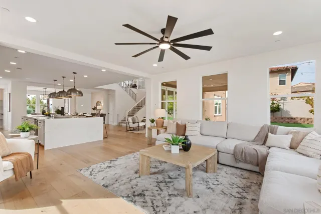 a living room with furniture and kitchen view