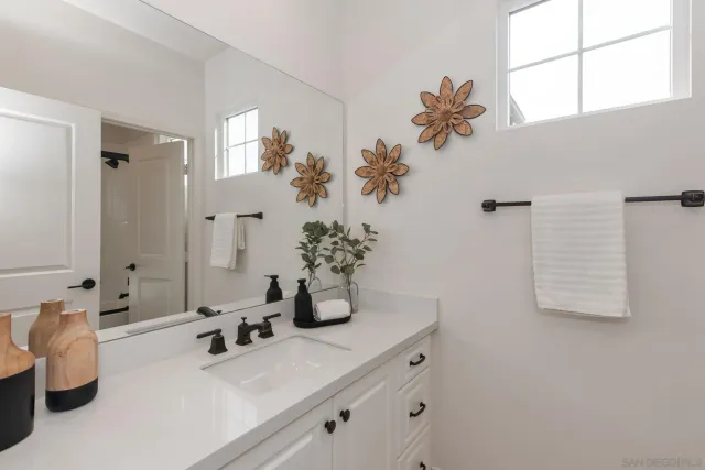 a bathroom with a double vanity sink and a mirror