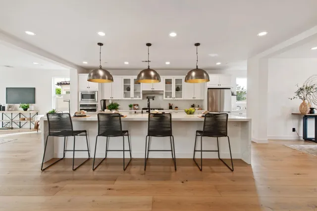 a view of open kitchen with dining table and chairs