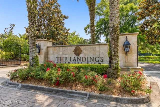 a sign that is in front of flowers