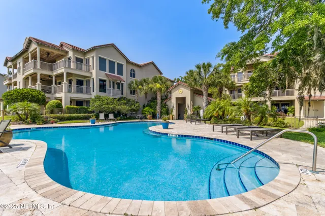 a view of a house with swimming pool and yard
