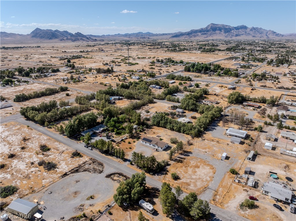 1890 West Dyer Road Pahrump, NV 89048 - Photo 28 of 40 Expansive desert vistas surround this tranquil property with mountain backdrops and scattered greenery.