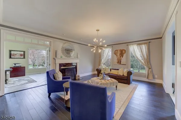 a living room with furniture fireplace and a large window