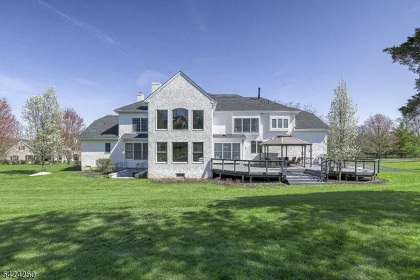 a view of a house with a yard and sitting area