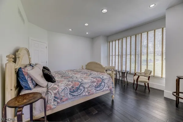 a bedroom with furniture and wooden floor