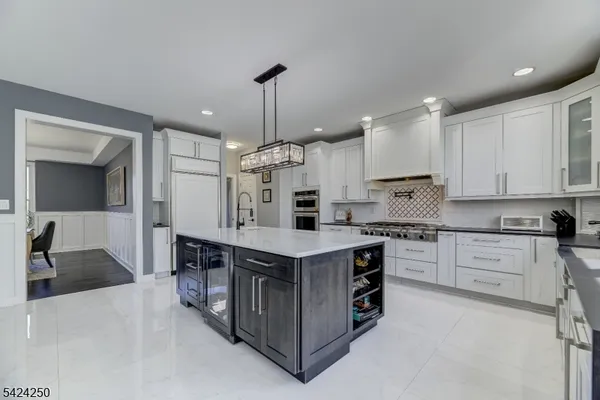 a kitchen with stainless steel appliances granite countertop a stove oven and a sink