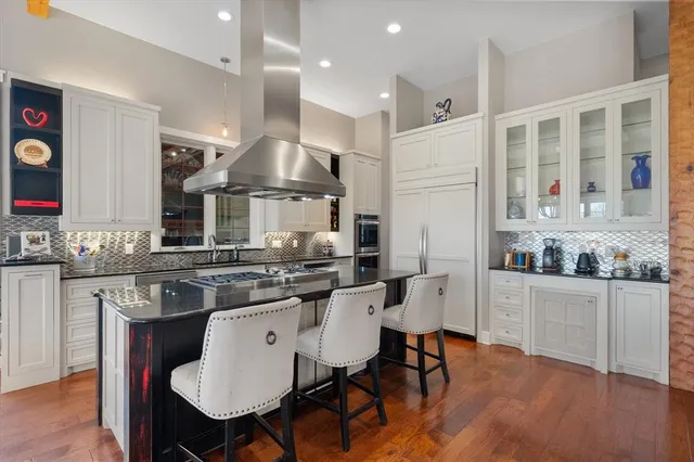 a kitchen that has a stove and a table