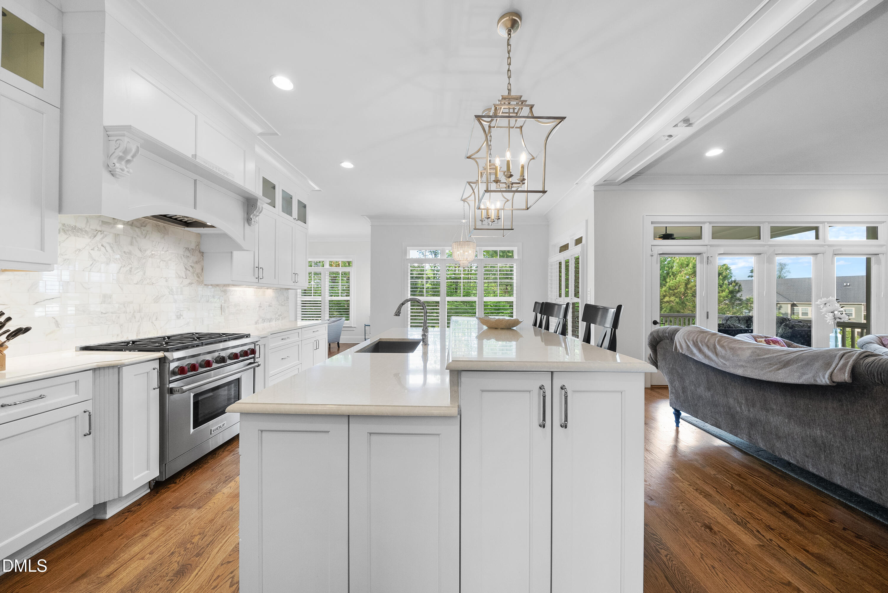 5109 Wainscott Way Raleigh, NC 27612 - Photo 14 of 52 a kitchen with stainless steel appliances granite countertop a sink stove and wooden floor