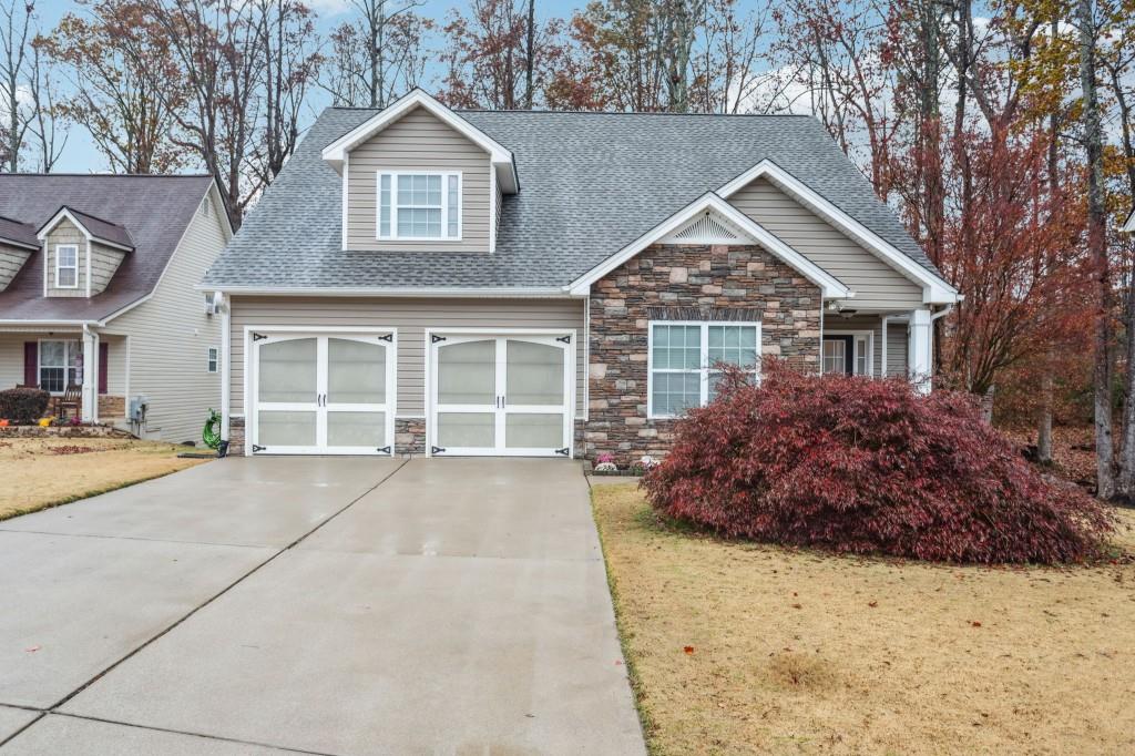 a front view of a house with a garden