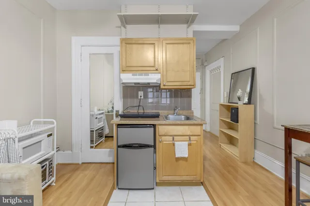 a kitchen with cabinets and window