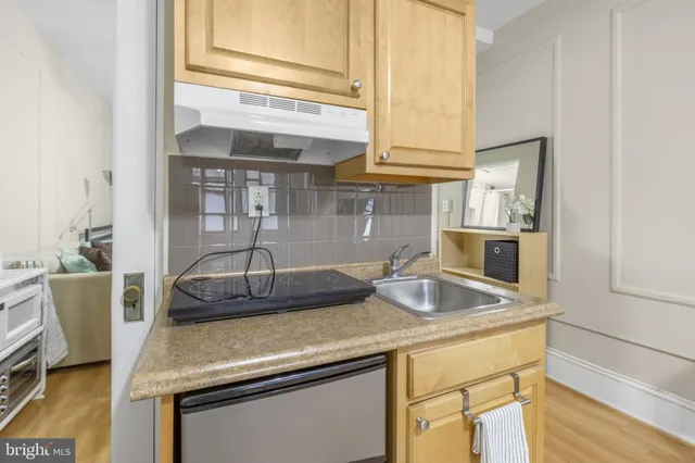 a kitchen with a sink and cabinets
