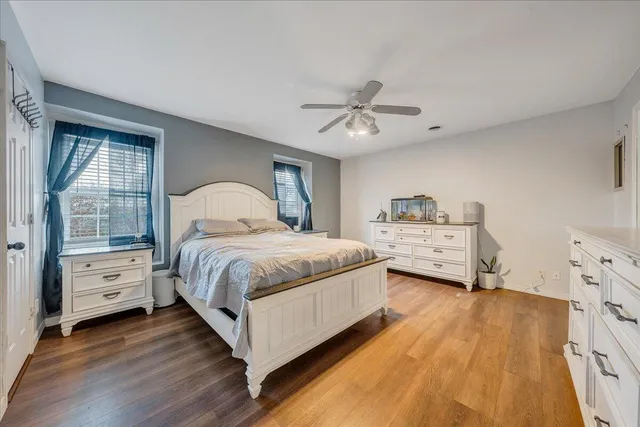 a spacious bedroom with a bed and a window