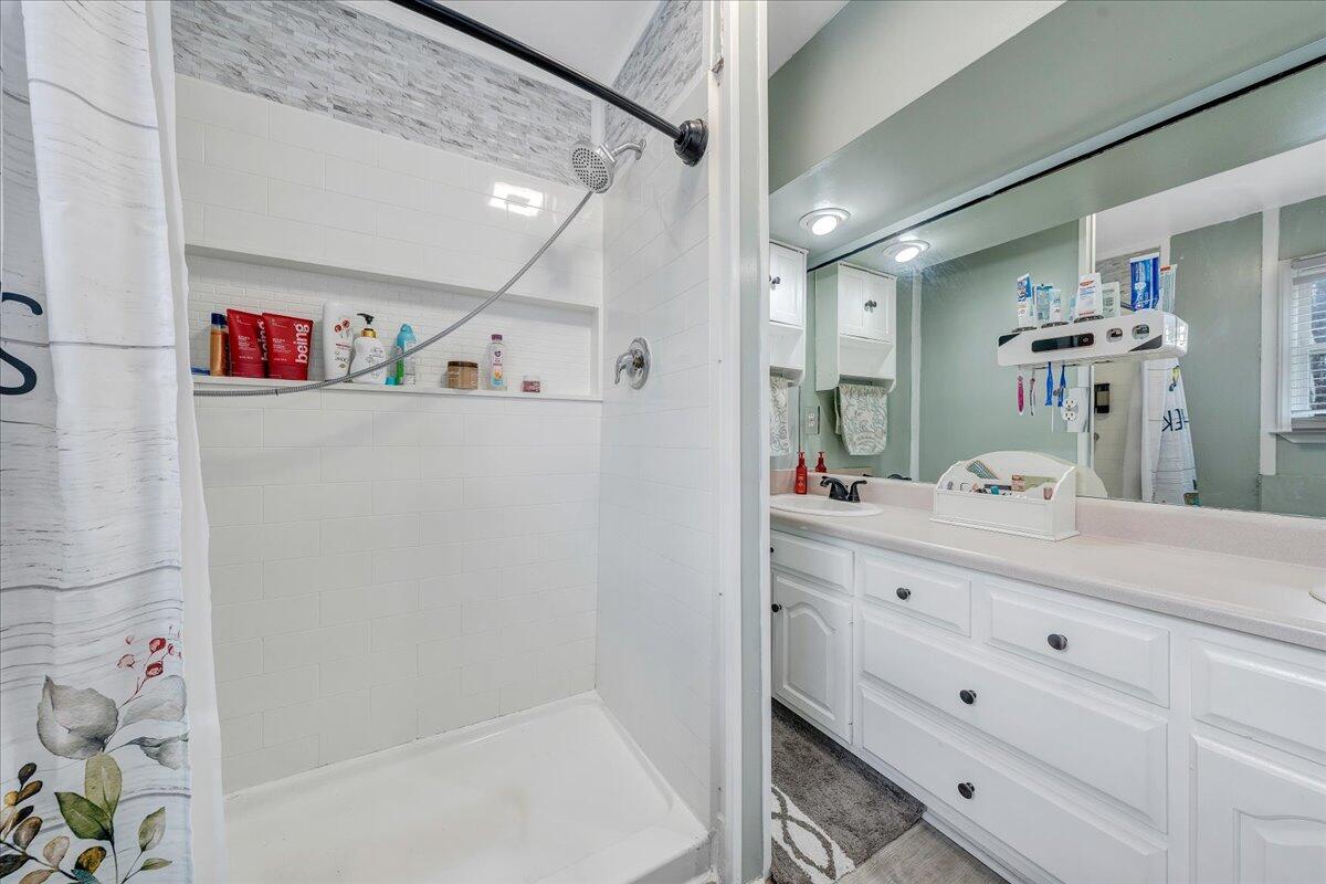65 Avon Street Rocky Mount, VA 24151 - Photo 19 of 46 a bathroom with a bathtub sink vanity and mirror