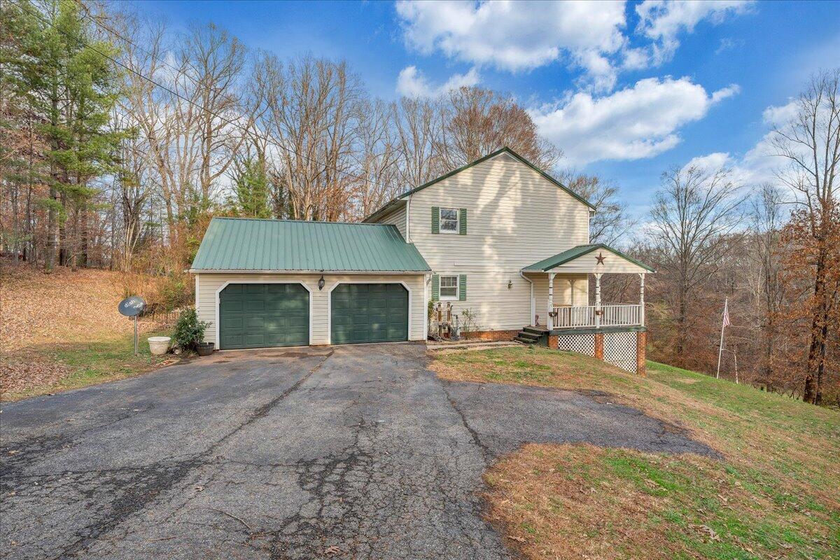 65 Avon Street Rocky Mount, VA 24151 - Photo 45 of 46 a front view of a house with a yard and garage