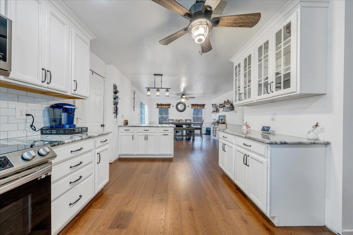 65 Avon Street Rocky Mount, VA 24151 - Photo 7 of 46 a kitchen with stainless steel appliances granite countertop hardwood floor sink stove and cabinets