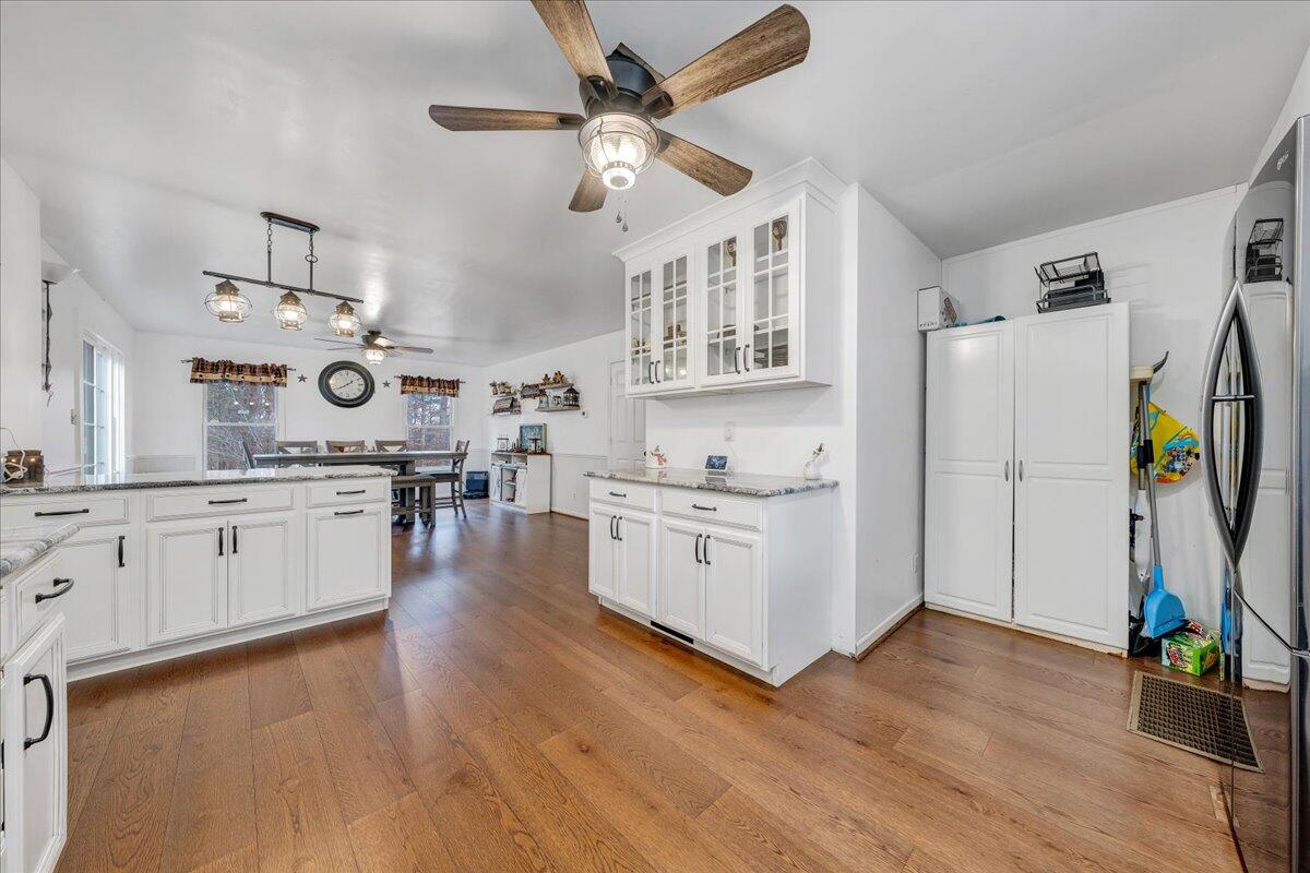 65 Avon Street Rocky Mount, VA 24151 - Photo 9 of 46 a kitchen with stainless steel appliances white cabinets and wooden floor