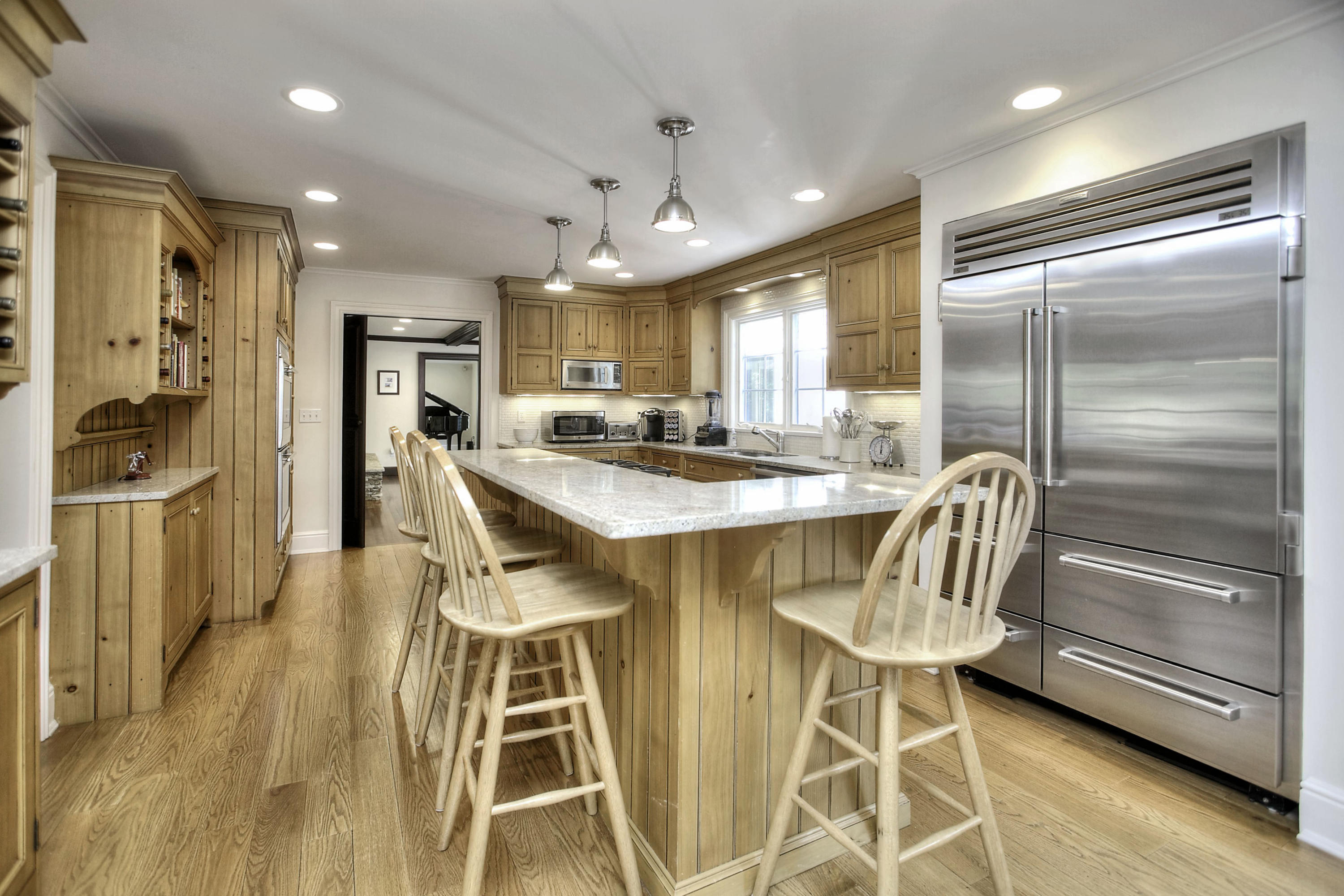 176 Marshall Ridge Road New Canaan, CT 06840 - Photo 3 of 29 a kitchen with stainless steel appliances kitchen island granite countertop a refrigerator and a dining table