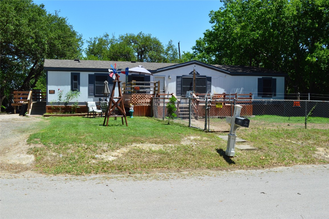 a front view of house with yard barbeque oven and outdoor seating