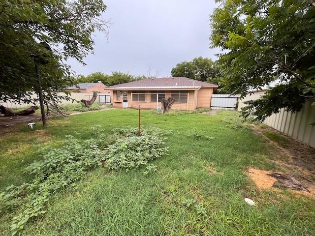 136 Northwest Ave F Hamlin, TX 79520 - Photo 22 of 27 a view of a yard in front of a house with a large tree