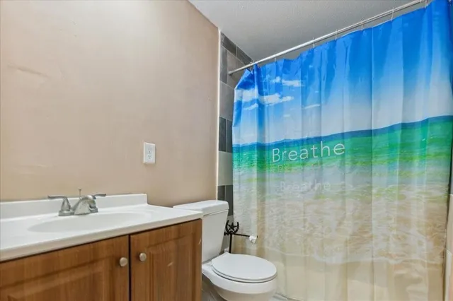a living room with furniture a fireplace and a floor to ceiling window